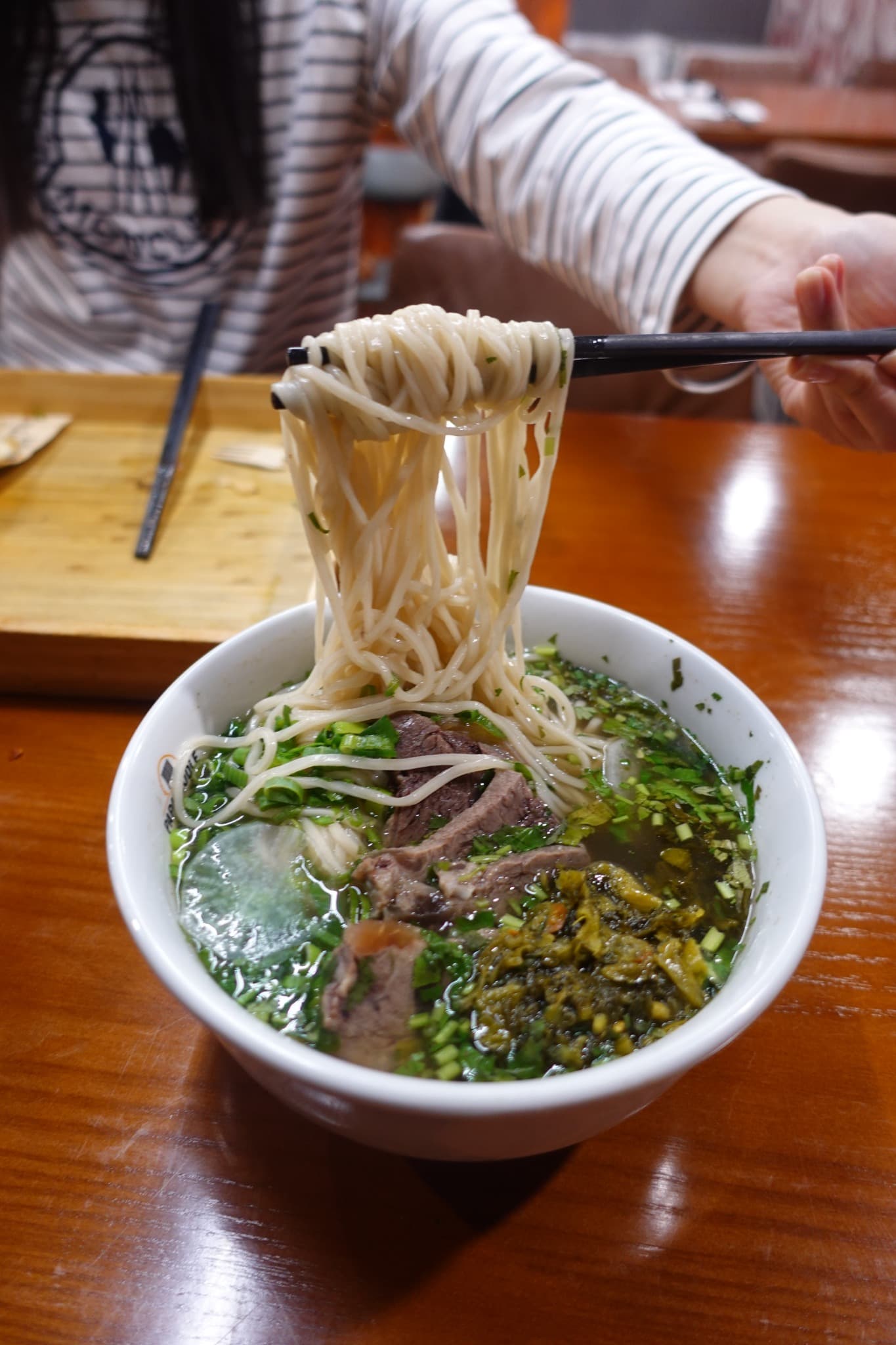 Fresh Papa Noodle noodles lifted from a bowl