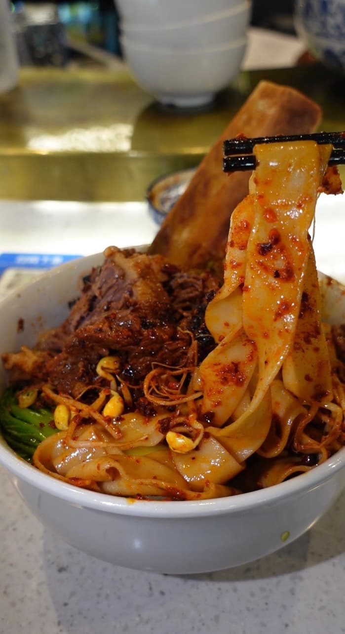 Enjoying our chilli-oil flat noodles