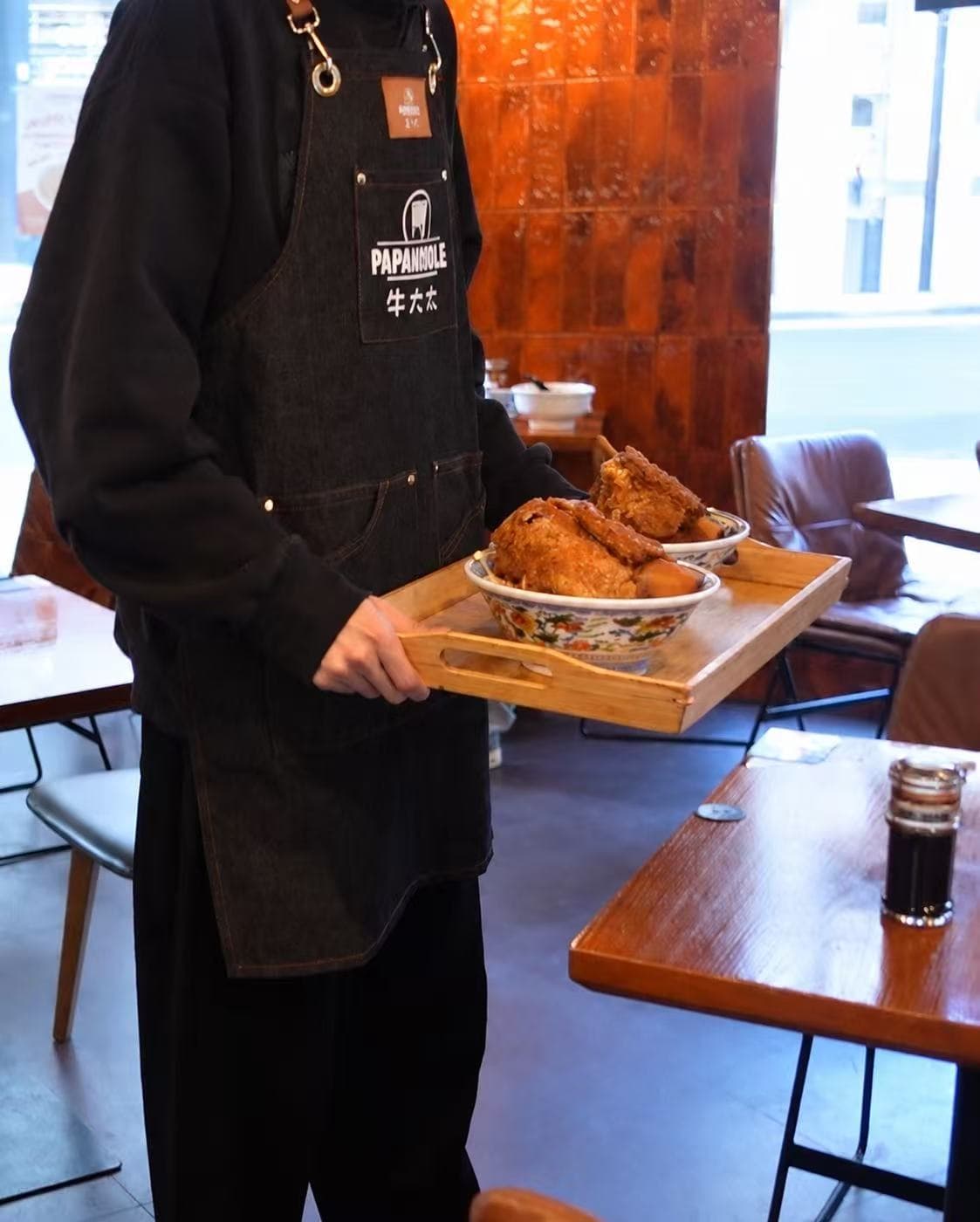 Papa Noodle team serving bowls of beef short rib noodles